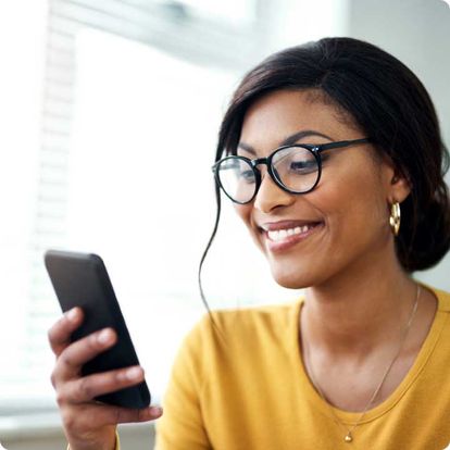 Smiling woman looking at her phone