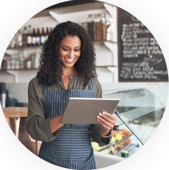 Restaurant worker holding a tablet while smiling