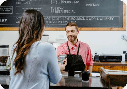 Restaurant worker handing payment terminal to customer