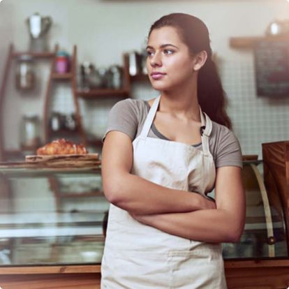Restaurant server standing with her arms crossed