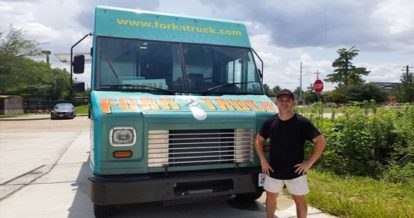 Martin lowe owner of fork and truck standing in front of his food truck