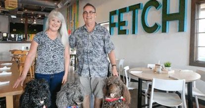 Fetch bistro owners and three curly haired dogs