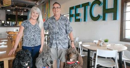Fetch bistro owners and three curly haired dogs