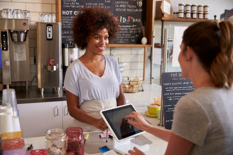 A customer ordering and paying on an iPad POS