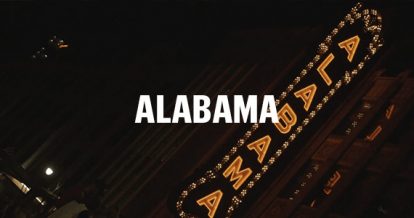 A picture of Alabama lit up sign at night and in bold 