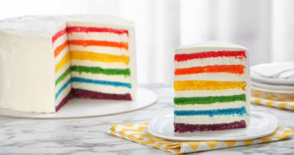 A slice of cake with a rainbow layered interior