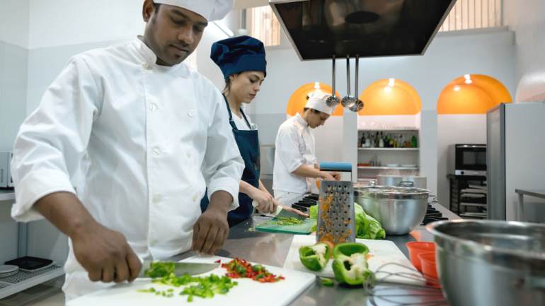 Restaurant back-of-house staff prepping vegetables