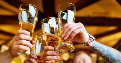 A group of people clinking beer glasses