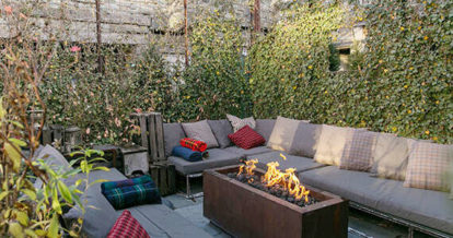 Outdoor patio seating with freestanding fireplace feature