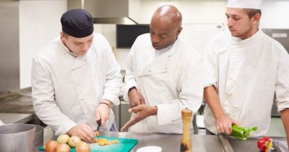 Chefs being mentored in a restaurant kitchen