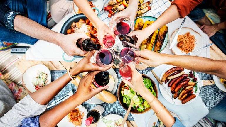 A group of friends clinking drinks on Labor Day