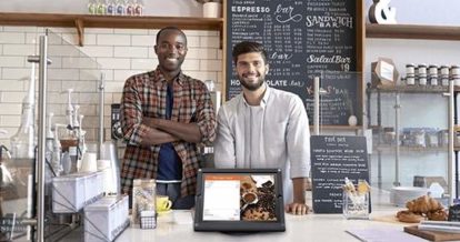 restaurant owners smiling with their POS