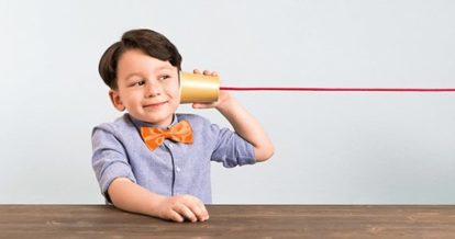 A child listening to a pretend telephone