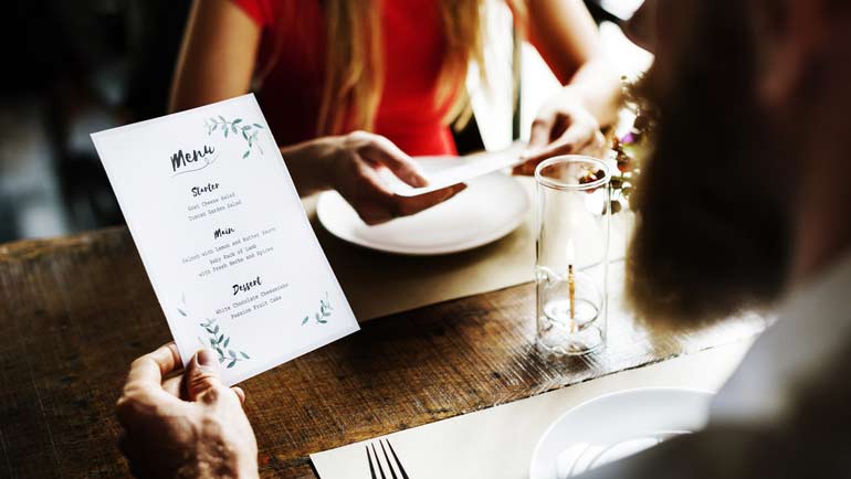 A couple looking at the menu before they order