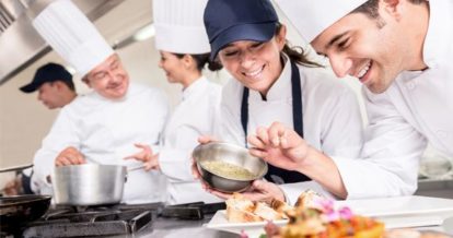 Chefs smiling and plating dishes