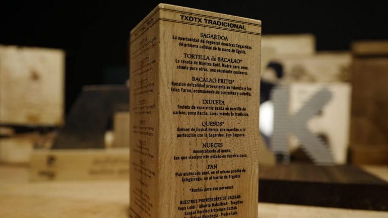 A menu engraved on a wooden block