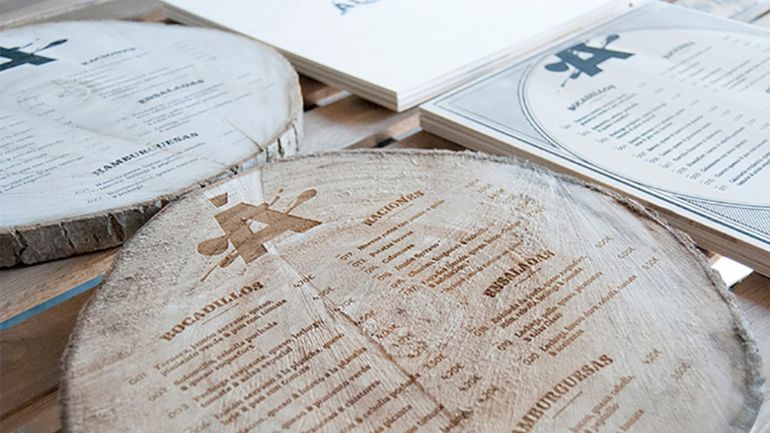 A menu engraved on a piece of log
