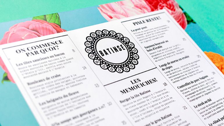 A simple black and white menu with a big logo in the middle
