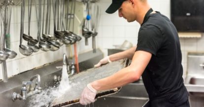 Back of house staff washing a sheet tray