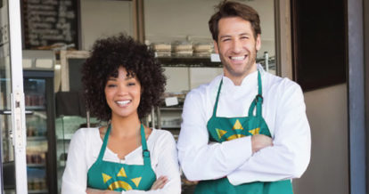 counter staff wearing branded aprons