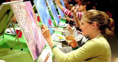 customers sipping wine while making a painting