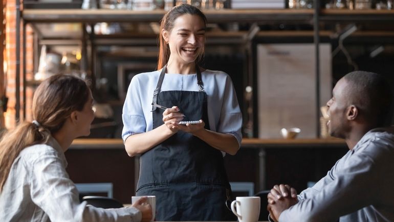 A waitress spending time with customers in the restaurant to prevent food theft instances.