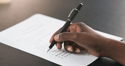 checking restaurant checklist with pen in hand