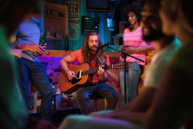 man playing acoustic guitar