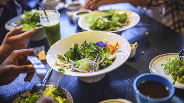 Bowl of greens at a restaurant table