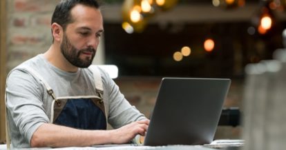 restaurant owner working on laptop