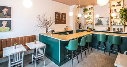 Interior of restaurant with counter and a few tables