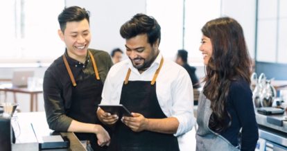 three staff members gathered around POS