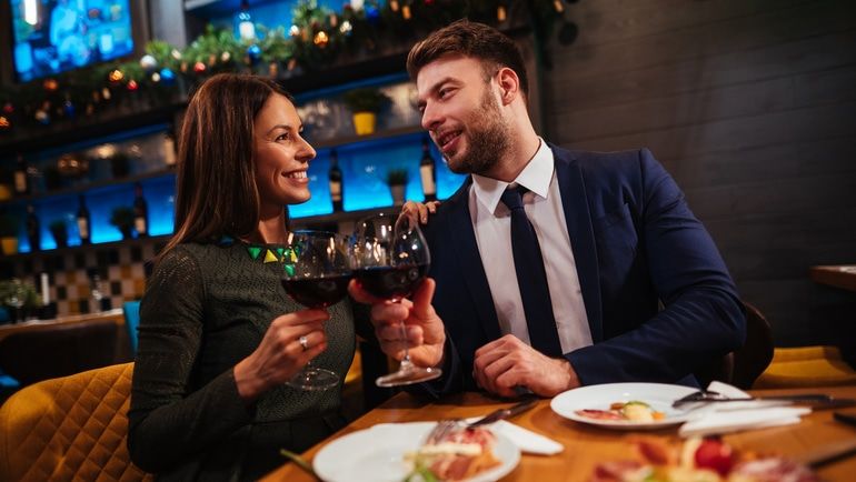 A man and woman drinking wine