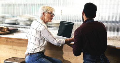 restaurant owner and manager working on a laptop