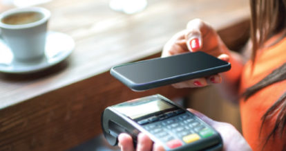 Customer paying for coffee with smartphone