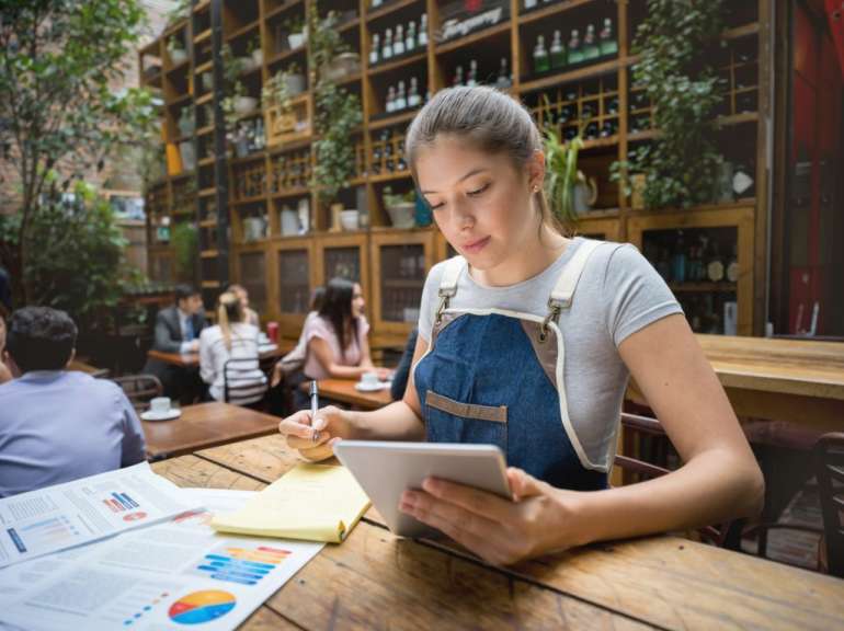 Woman doing the books at a restaurant