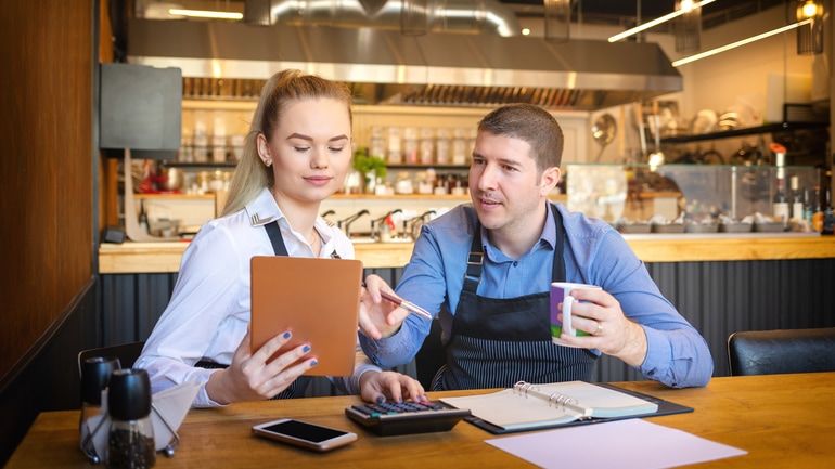 Two restaurant workers going over the finances