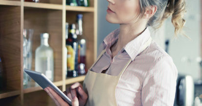 A woman looking at her inventory on her iPad