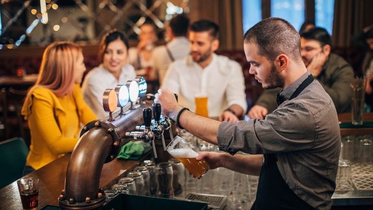 Bartender pouring beer in a pub