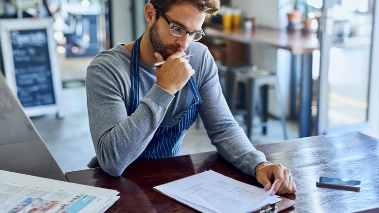 Restaurant owner reviewing his financials