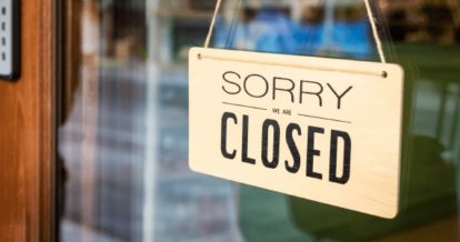 Sorry closed sign hanging in restaurant window