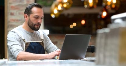 Restaurant owner browsing for government relief programs online