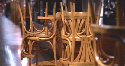Chairs placed on top of restaurant tables