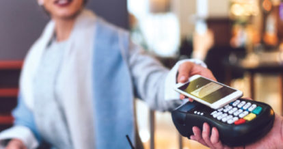 A customer paying with her phone