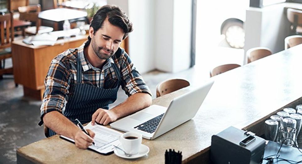 restaurant owner working at laptop