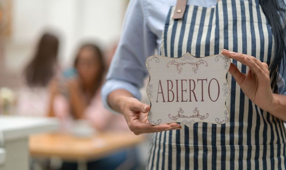 server holds an open sign