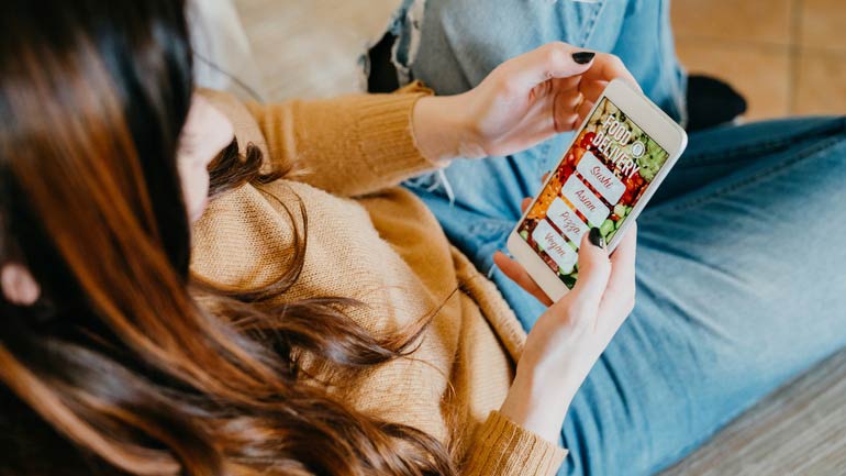 A customer reading a menu off her phone