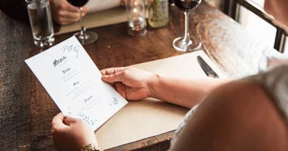 A customer reading a menu