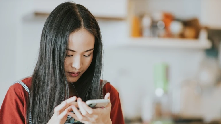 A woman scrolling on her phone