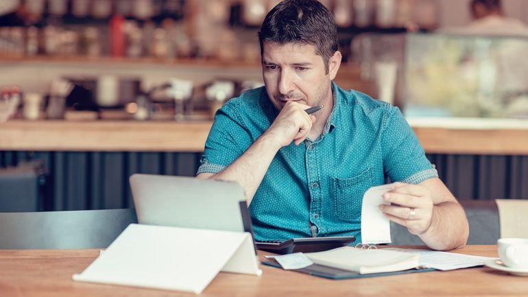 Restaurant owner going over his financials with a tablet